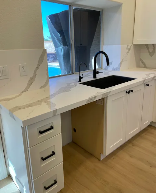 Kitchen remodel with a waterfall quartz island and custom white cabinets by Orange Cactus Remodeling, serving Mesa, AZ
