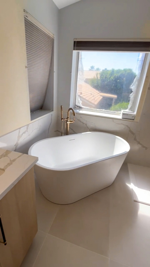 Freestanding soaking tub beside a window in a bathroom remodel by Orange Cactus Remodeling, serving Dobson Ranch, Mesa, AZ
